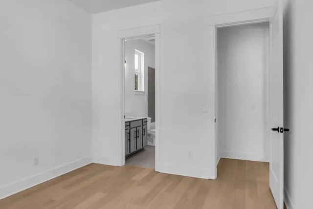 a kitchen with granite countertop white cabinets and stainless steel appliances