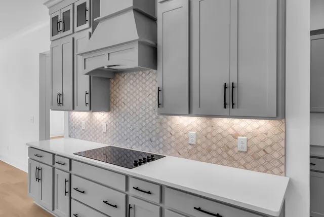 an empty room with a fireplace and windows