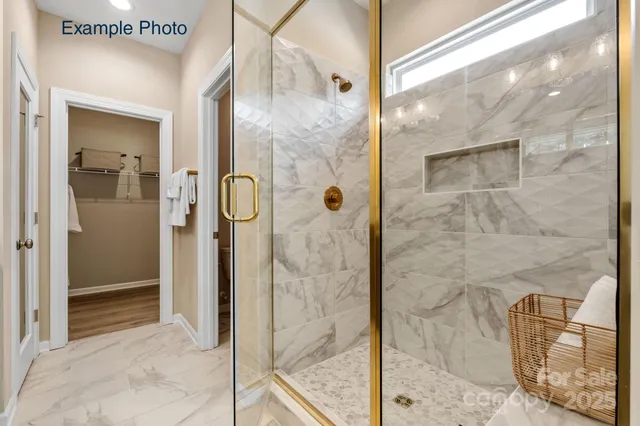 a bathroom with a glass shower door and a mirror