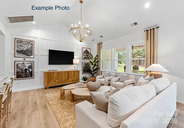 a living room with fireplace furniture and a flat screen tv