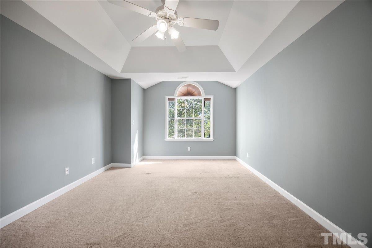 716 Saratoga Drive Durham, NC 27704 - Photo 13 of 30 an empty room with windows and chandelier fan