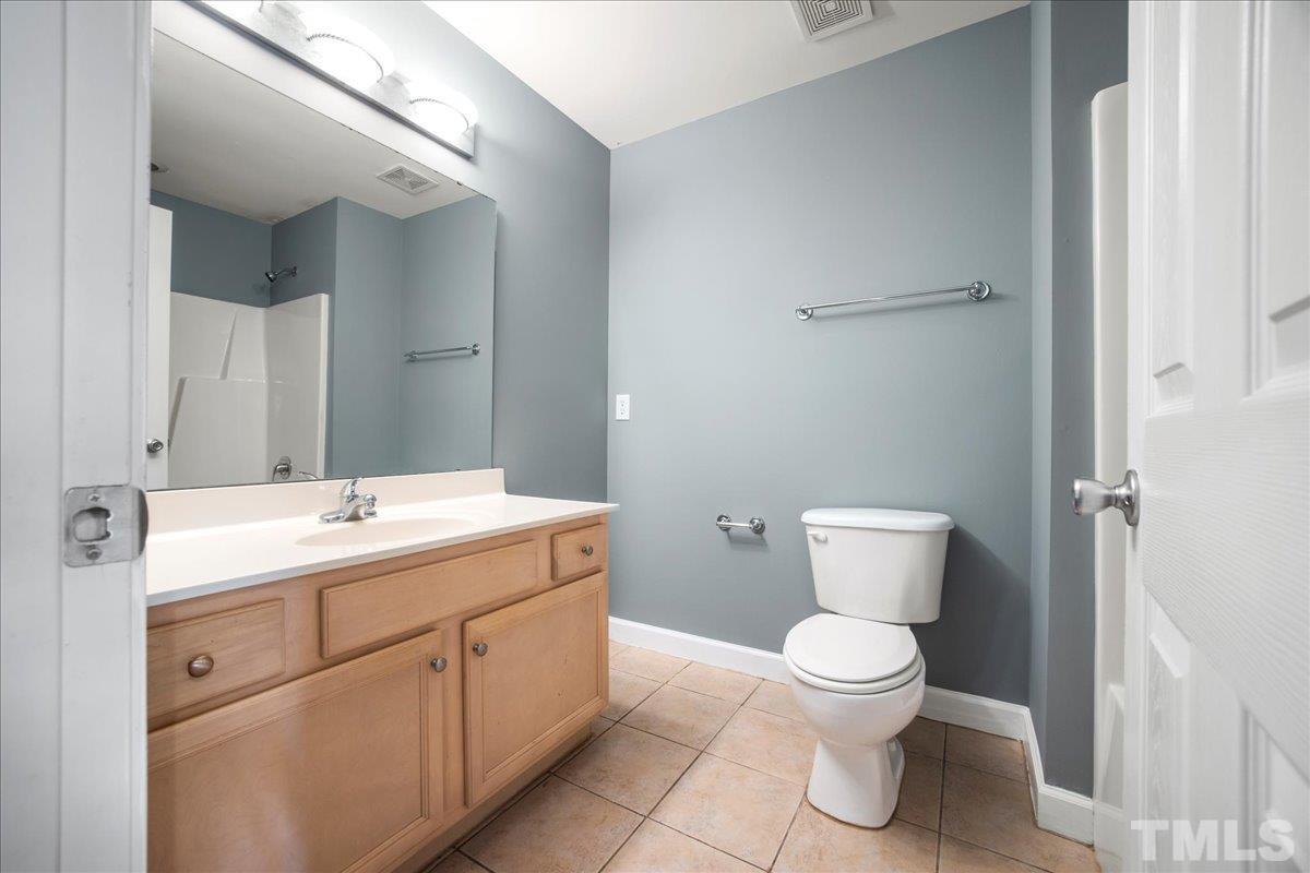 716 Saratoga Drive Durham, NC 27704 - Photo 19 of 30 a bathroom with a toilet sink and mirror
