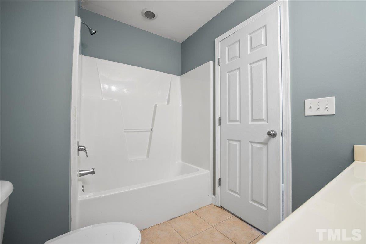 716 Saratoga Drive Durham, NC 27704 - Photo 20 of 30 a bathroom with a bathtub and a shower
