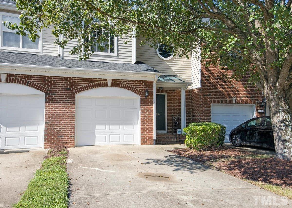 716 Saratoga Drive Durham, NC 27704 - Photo 2 of 30 a front view of a house with a yard and a garage