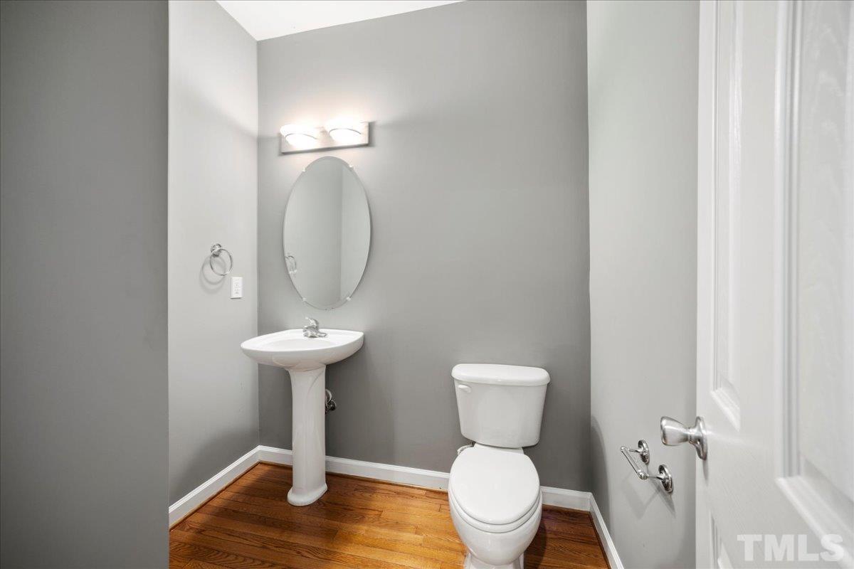 716 Saratoga Drive Durham, NC 27704 - Photo 4 of 30 a bathroom with a toilet sink and mirror