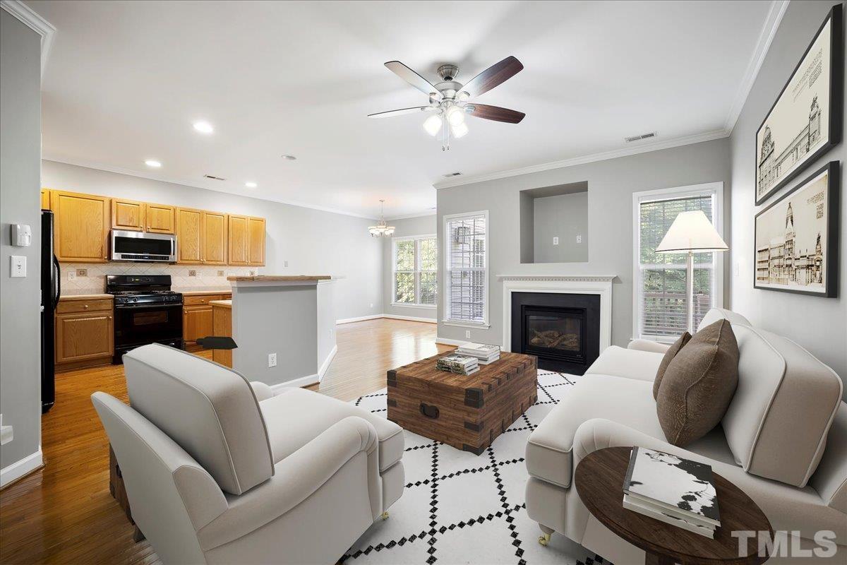 716 Saratoga Drive Durham, NC 27704 - Photo 6 of 30 a living room with furniture a fireplace and kitchen view