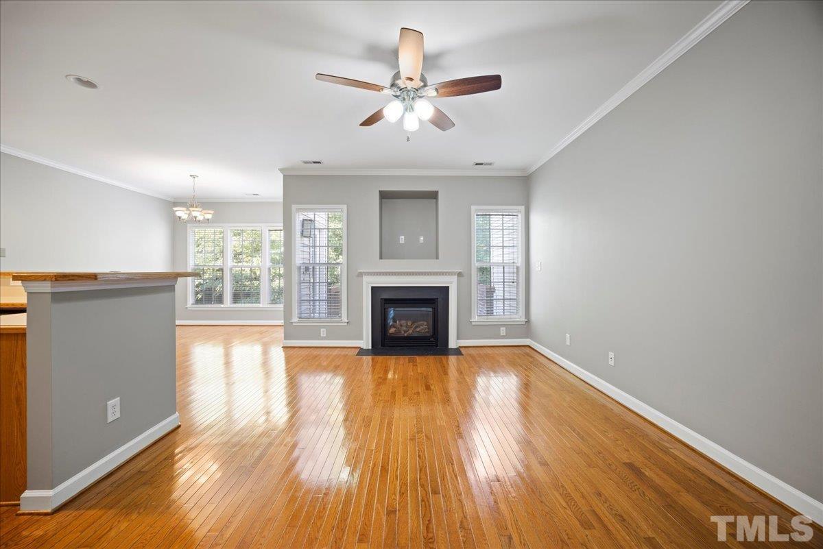 716 Saratoga Drive Durham, NC 27704 - Photo 7 of 30 wooden floor fireplace and windows in an empty room