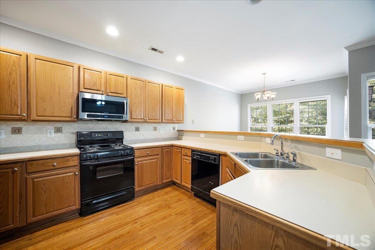 716 Saratoga Drive Durham, NC 27704 - Photo 8 of 30 a kitchen with a sink stove top oven and refrigerator