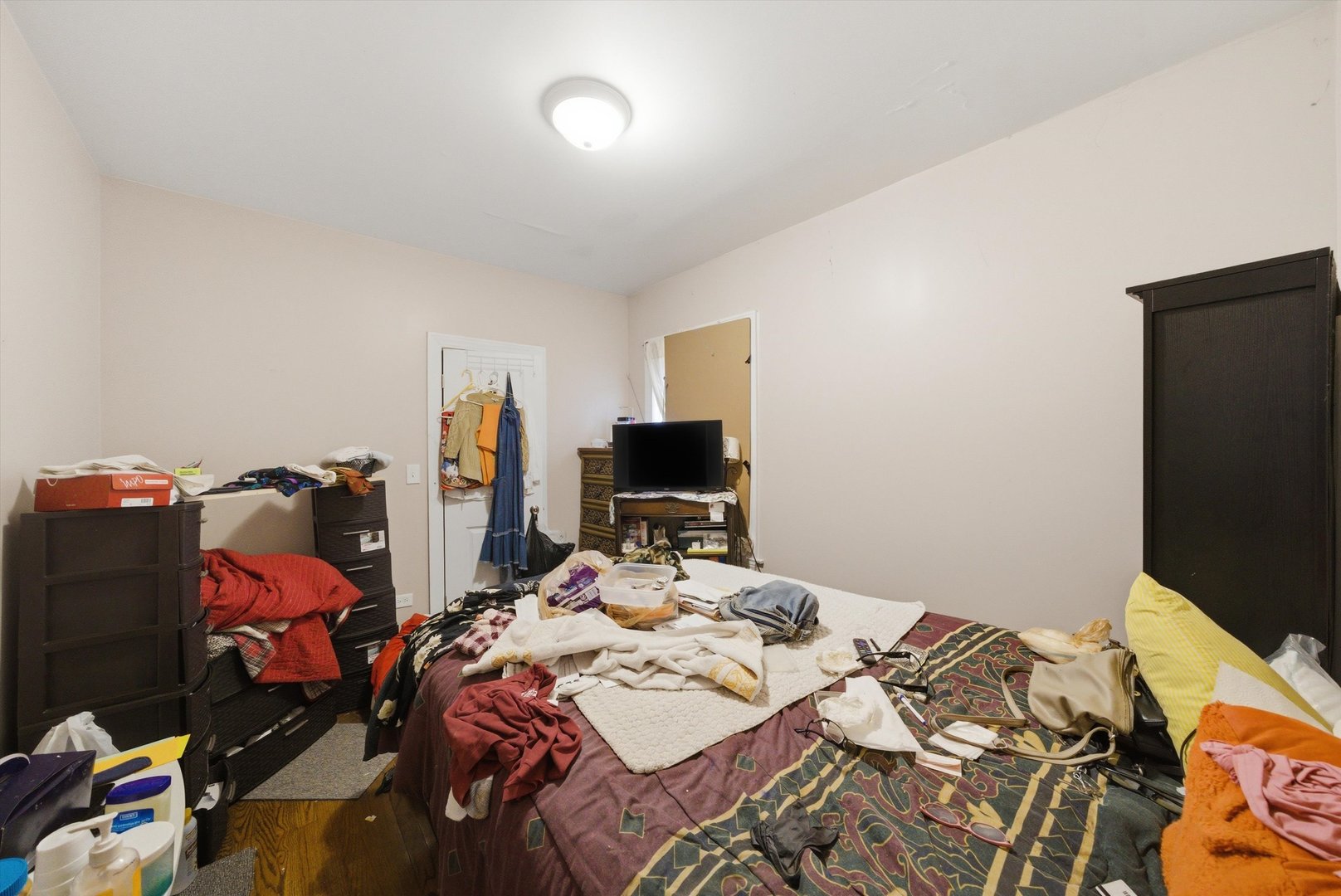 6837 South Morgan Street Chicago, IL 60621 - Photo 7 of 24 a bed sitting in a bedroom next to a tv and a computer