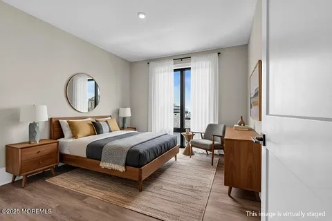 a living room with a bed furniture and a large window