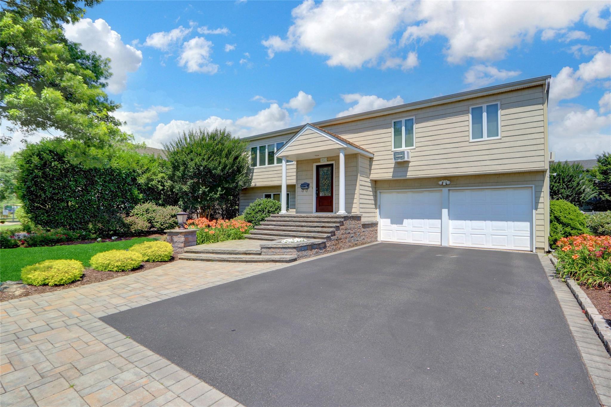 3023 Ira Road Bellmore, NY 11710 - Photo 1 of 1 a front view of house with yard and trees around