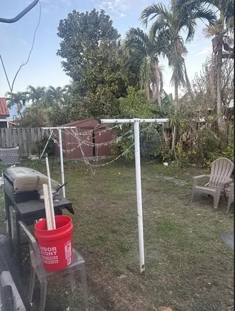 a backyard of a house with table and chairs