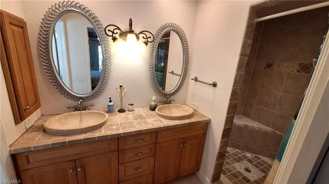 a bathroom with a granite countertop toilet a sink and a mirror