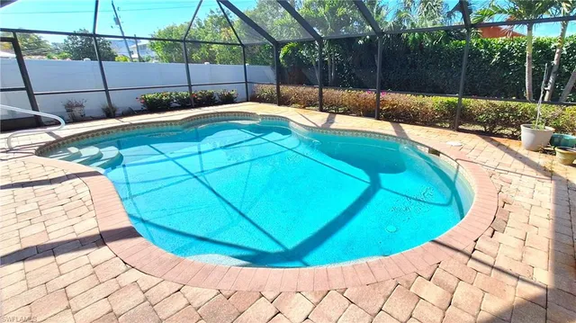 a view of a swimming pool with a yard and sitting area