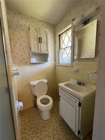a bathroom with a toilet and a sink