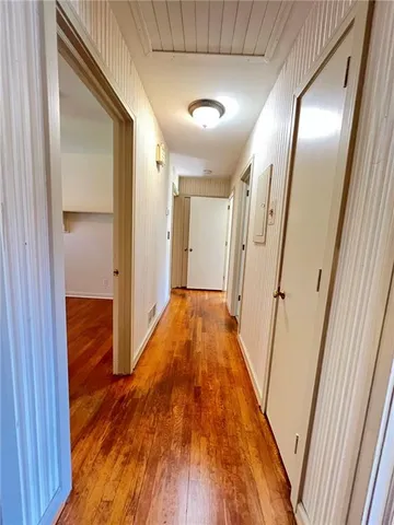 a view of hallway with wooden floor