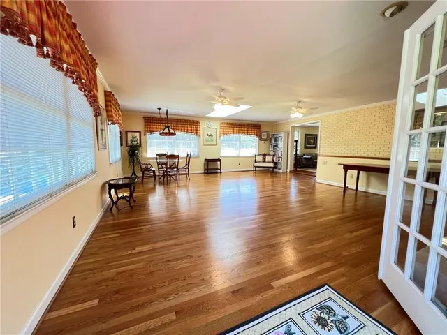 a hallway with wooden floor and furniture