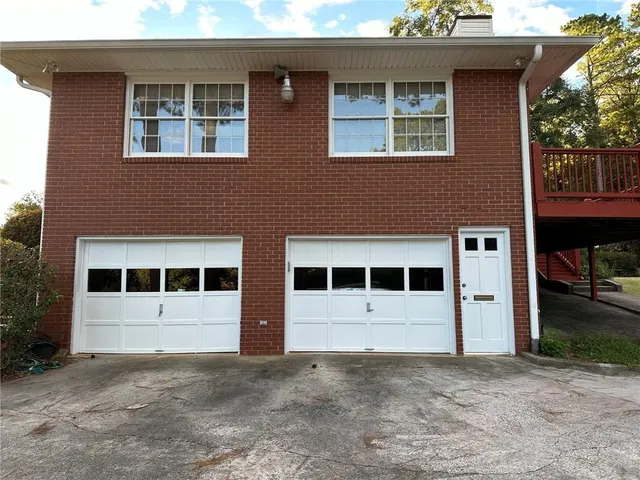 a view of a house with a yard and garage