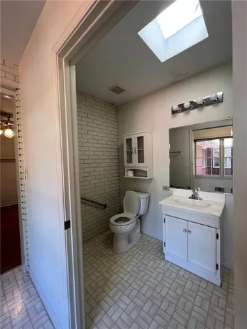 a bathroom with a toilet a sink and mirror