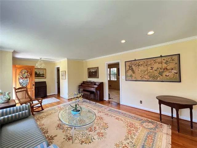 a living room with furniture a rug and a wooden floor