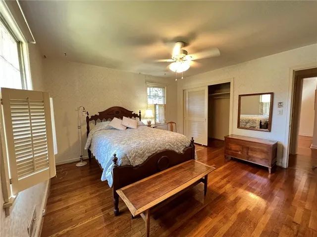 a spacious bedroom with a bed and a chandelier