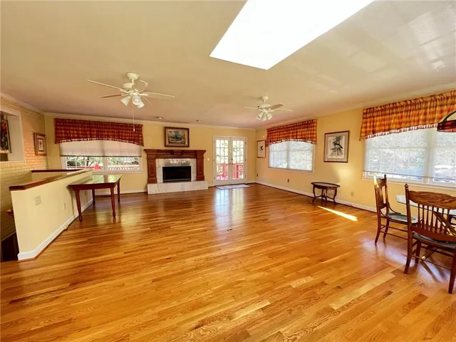 a large room with wooden floor and dining table