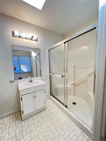 a bathroom with a sink a mirror and a shower