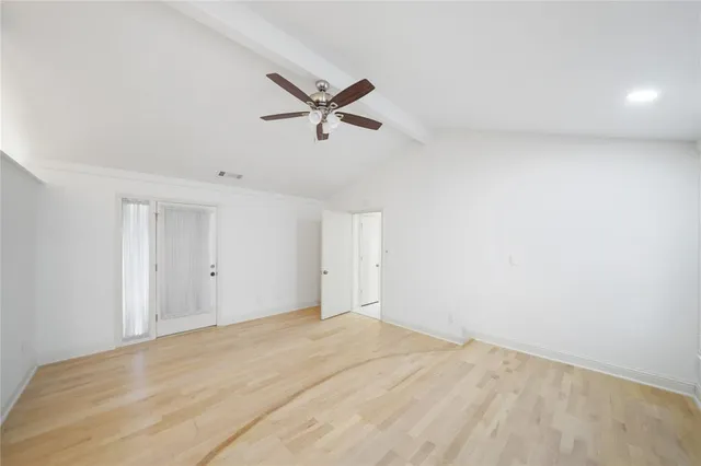 an empty room with windows and entrance