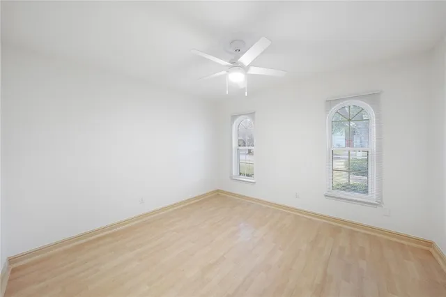 an empty room with windows and closet
