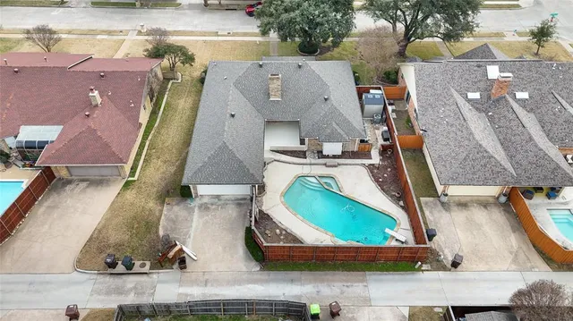 an aerial view of a house with a swimming pool