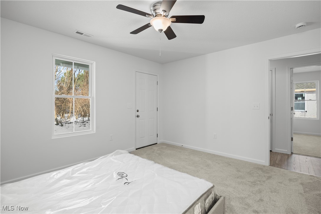 1999 East Oldgate Road Sandusky, OH 44870 - Photo 21 of 32 Carpeted bedroom featuring ceiling fan and baseboards