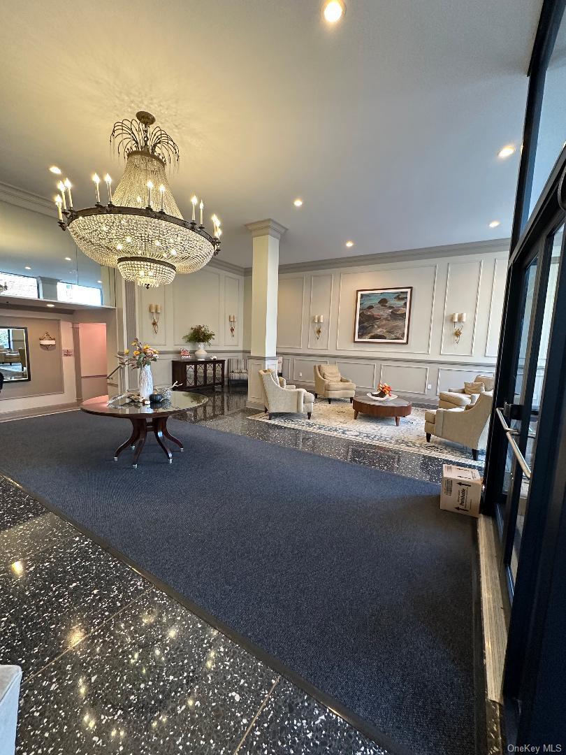 700 Shore Road, Unit 6EE Long Beach, NY 11561 - Photo 3 of 13 a living room with furniture and a chandelier