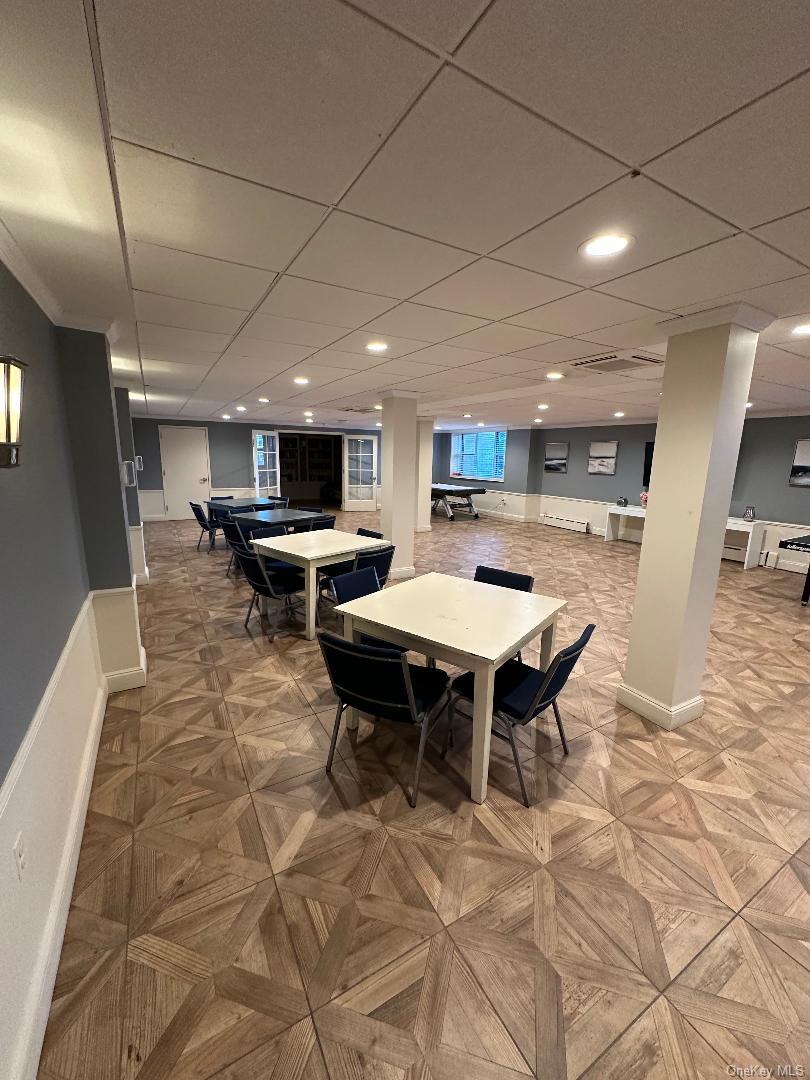 700 Shore Road, Unit 6EE Long Beach, NY 11561 - Photo 8 of 13 a open kitchen with stainless steel appliances kitchen island granite countertop a table chairs sink and cabinets