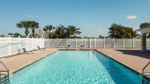 a view of a swimming pool with an outdoor seating and yard