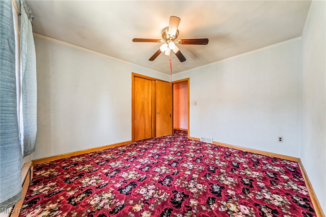 550 Cooper Foster Park Road Lorain, OH 44053 - Photo 19 of 50 Unfurnished bedroom featuring a ceiling fan, crown molding, and carpet flooring