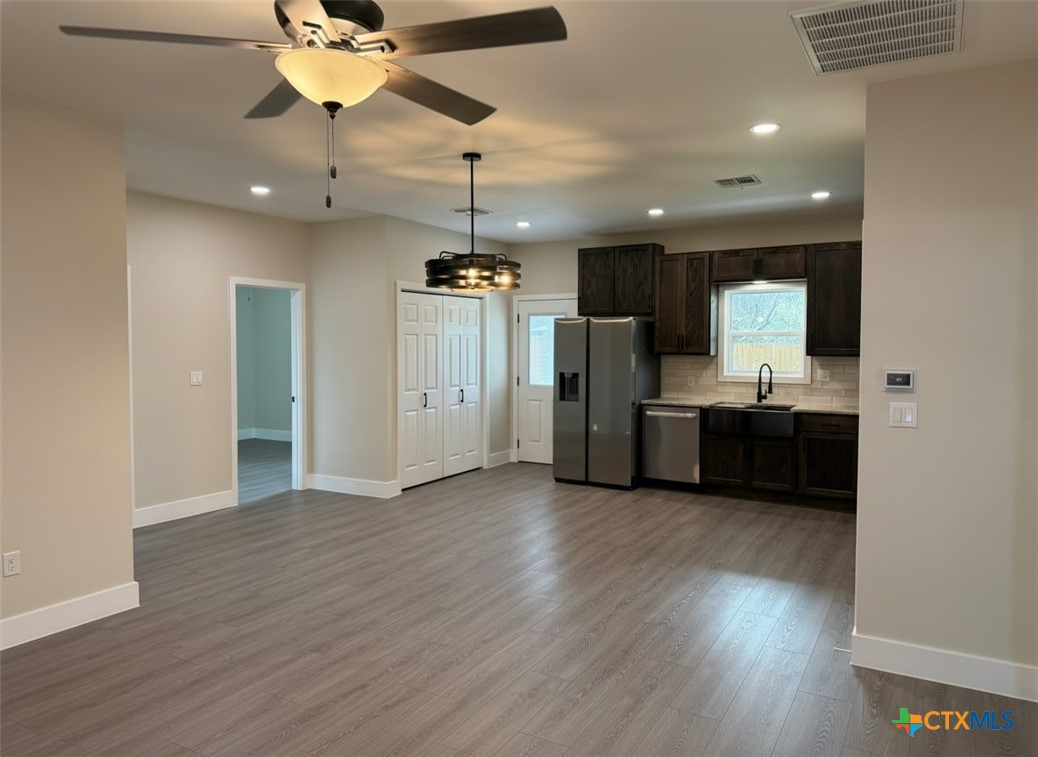 205 Haller Street Yoakum, TX 77995 - Photo 6 of 12 a view of a kitchen with a sink and stainless steel appliances