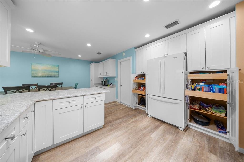 8720 Southwest 90th Street, Unit A Ocala, FL 34481 - Photo 17 of 71 a kitchen with white cabinets and white appliances