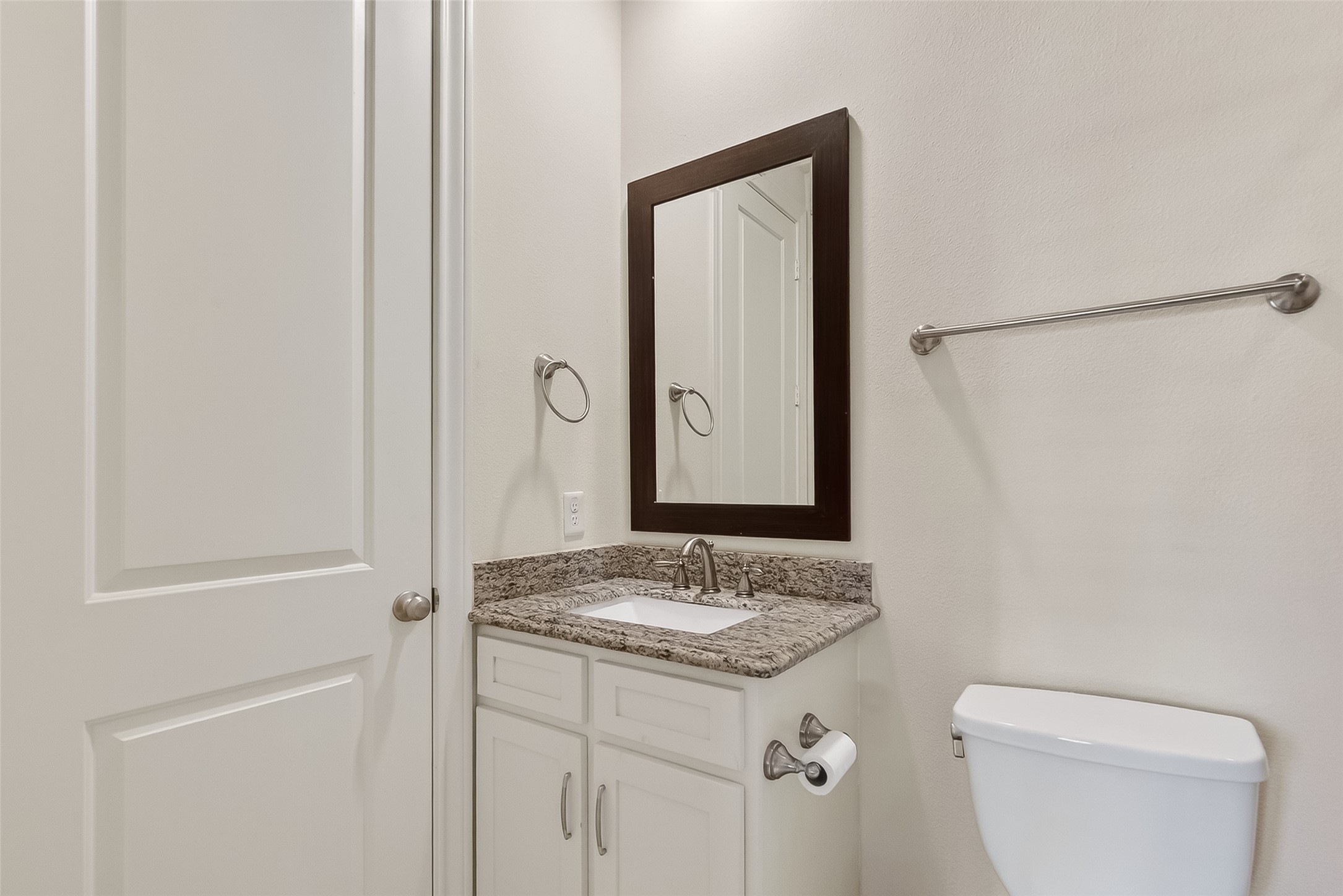 705 Delano Street Houston, TX 77003 - Photo 15 of 47 a bathroom with a granite countertop sink and a mirror
