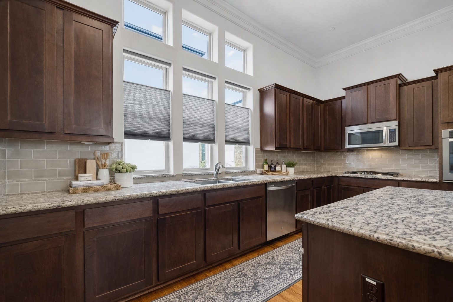 705 Delano Street Houston, TX 77003 - Photo 17 of 47 a kitchen with stainless steel appliances granite countertop wooden cabinets a stove a sink and dishwasher