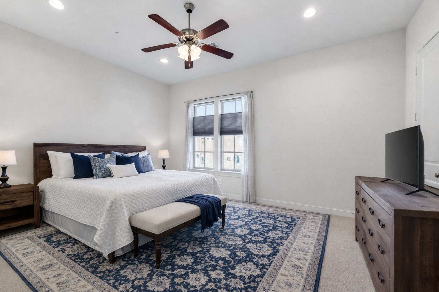 705 Delano Street Houston, TX 77003 - Photo 27 of 47 a bedroom with a large bed and a tv