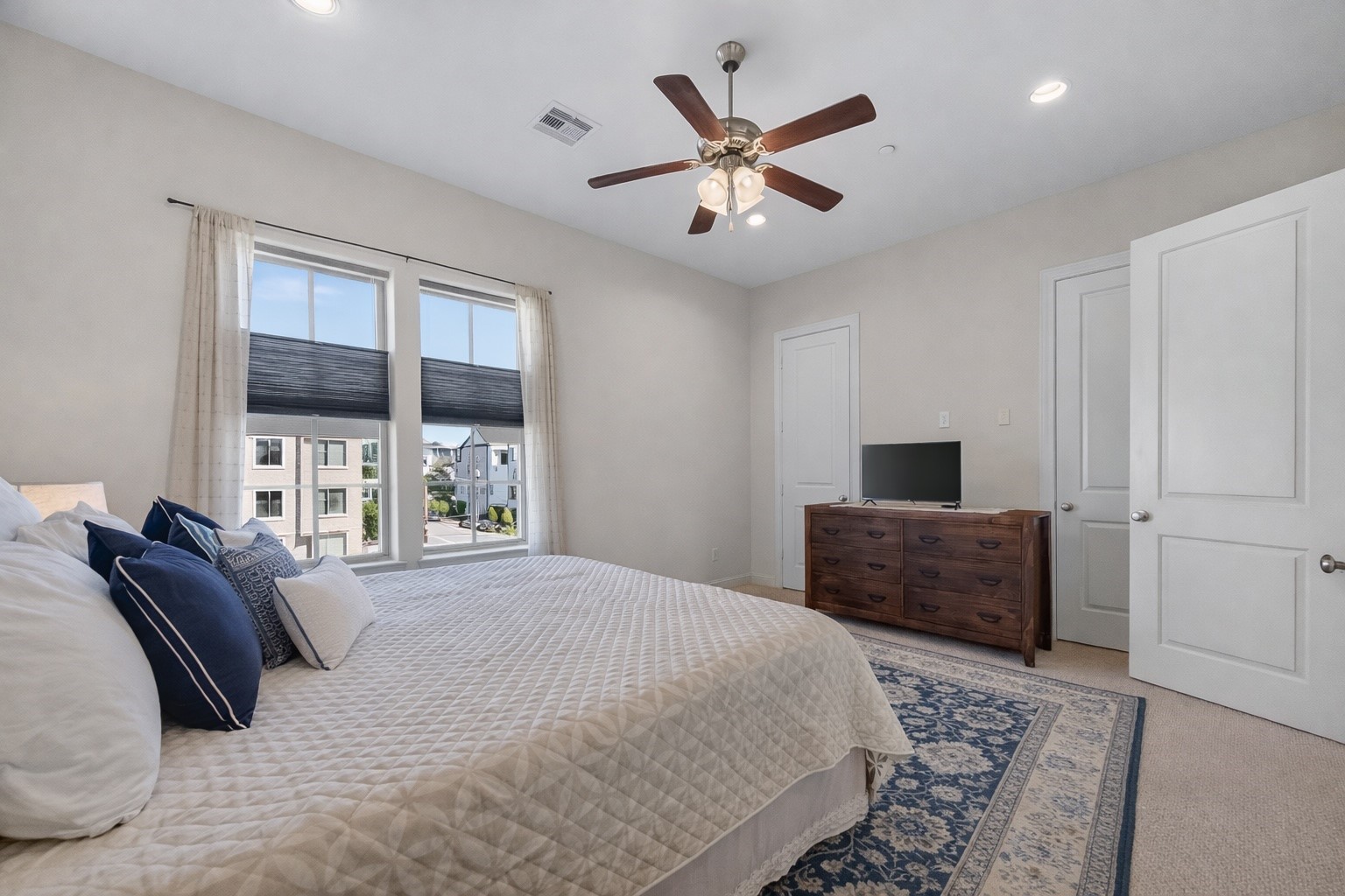 705 Delano Street Houston, TX 77003 - Photo 28 of 47 a bedroom with a large bed and a window