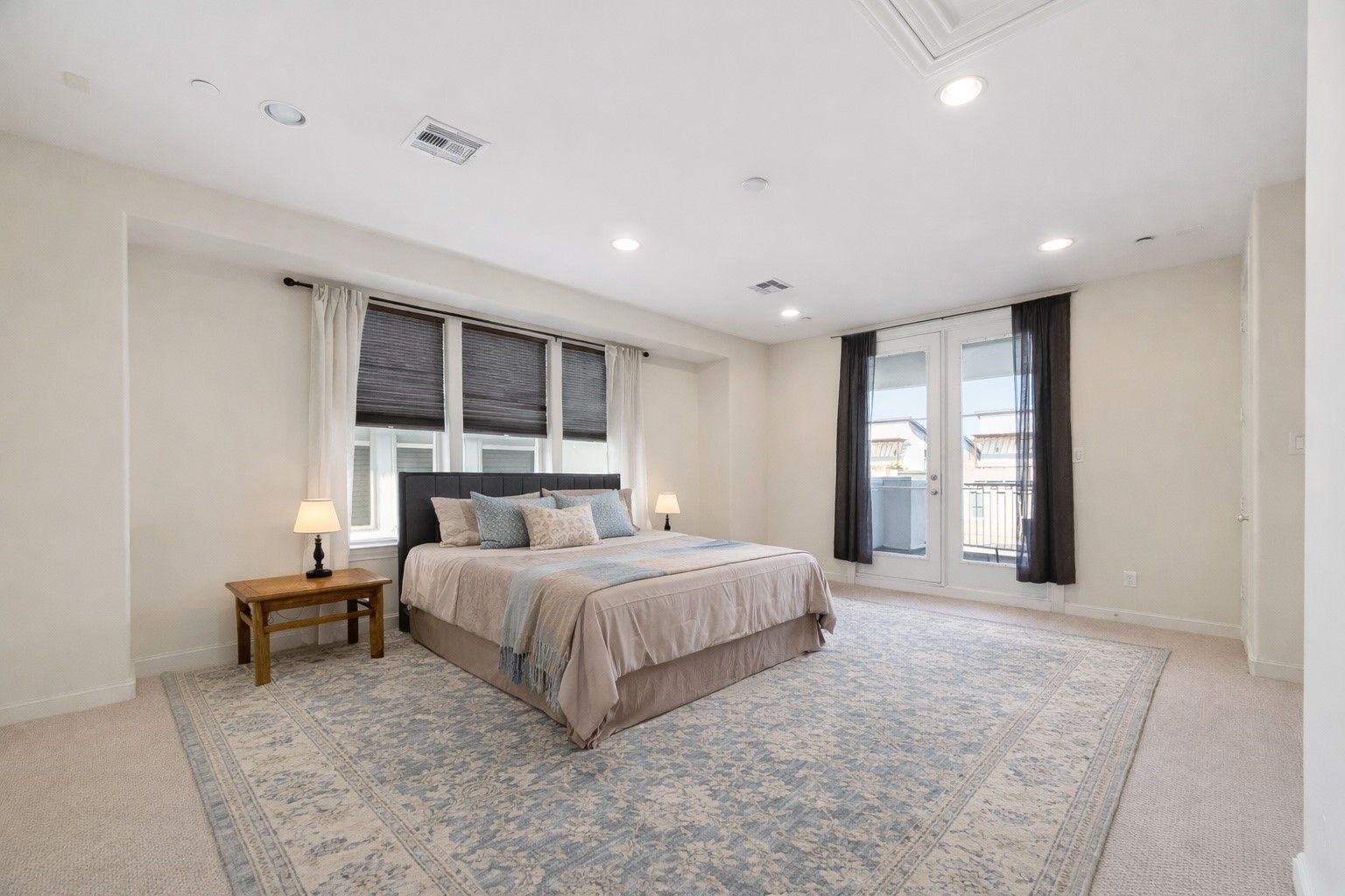 705 Delano Street Houston, TX 77003 - Photo 35 of 47 a spacious bedroom with a large bed and a window