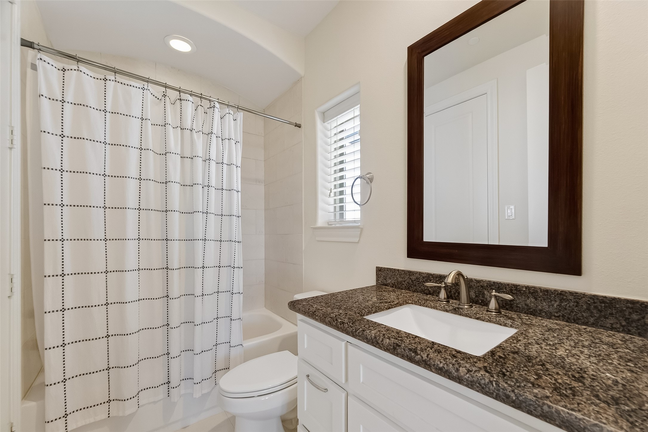 705 Delano Street Houston, TX 77003 - Photo 37 of 47 a bathroom with a granite countertop sink a toilet a mirror and shower
