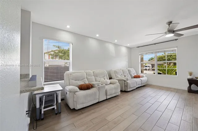 a open kitchen with stainless steel appliances granite countertop a refrigerator a stove a sink dishwasher with a dining table and chairs