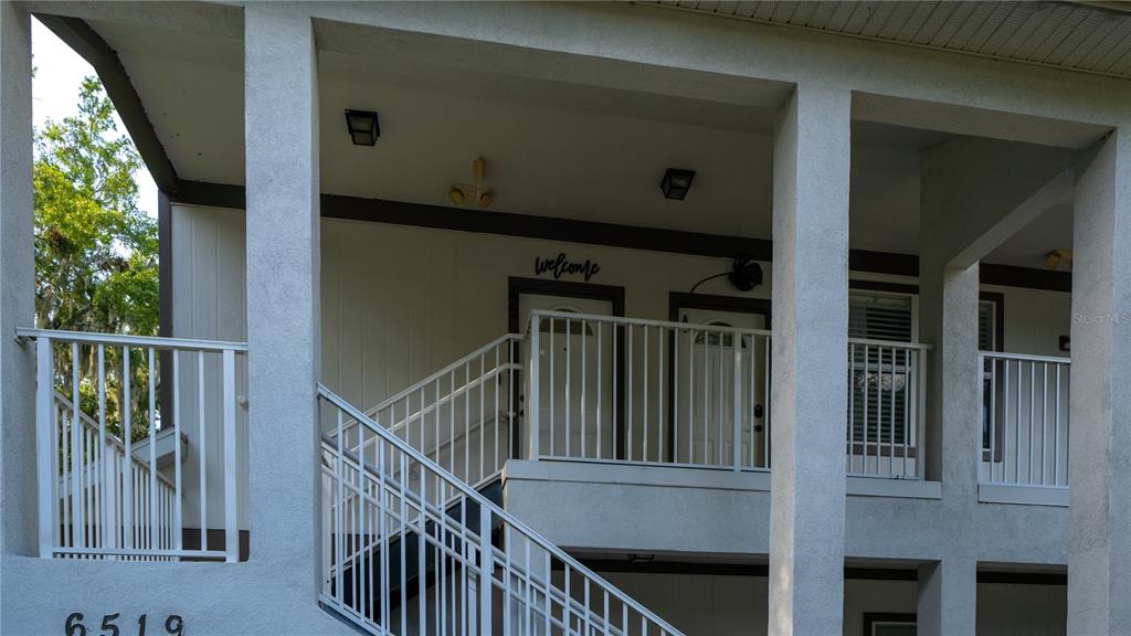 Undisclosed Address Gainesville, FL 32607 - Photo 3 of 21 a view of balcony with wooden floor and stairs