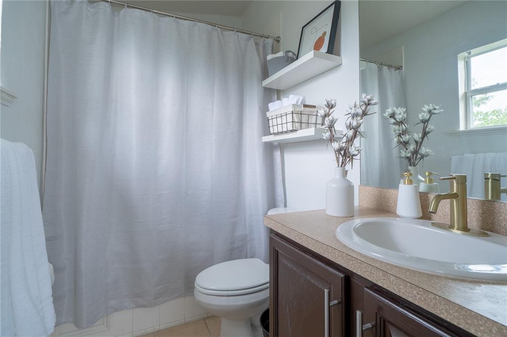 Undisclosed Address Gainesville, FL 32607 - Photo 7 of 21 a bathroom with a granite countertop sink and a toilet