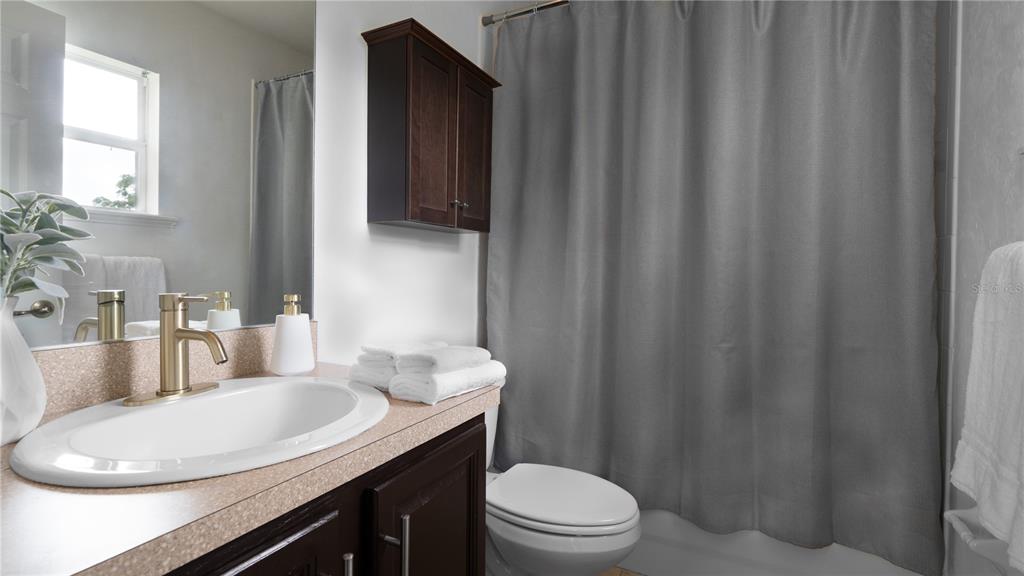 Undisclosed Address Gainesville, FL 32607 - Photo 8 of 21 a bathroom with a sink a toilet and vanity