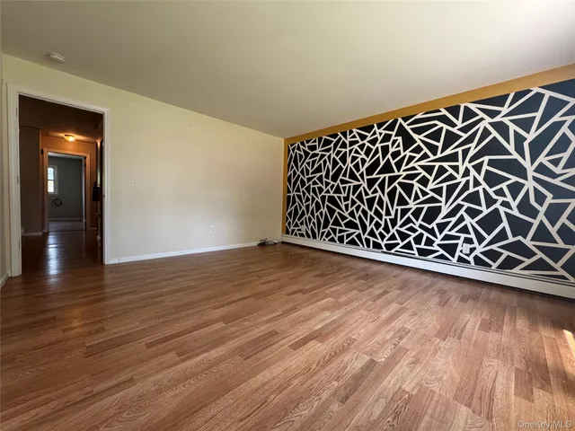 a view of a room with wooden floor