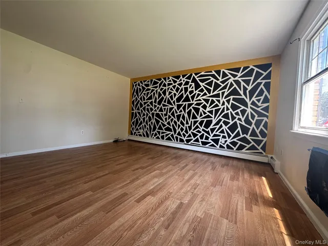 a view of a room with wooden floor and staircase