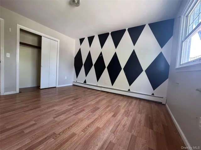 an entryway view with wooden floor and windows